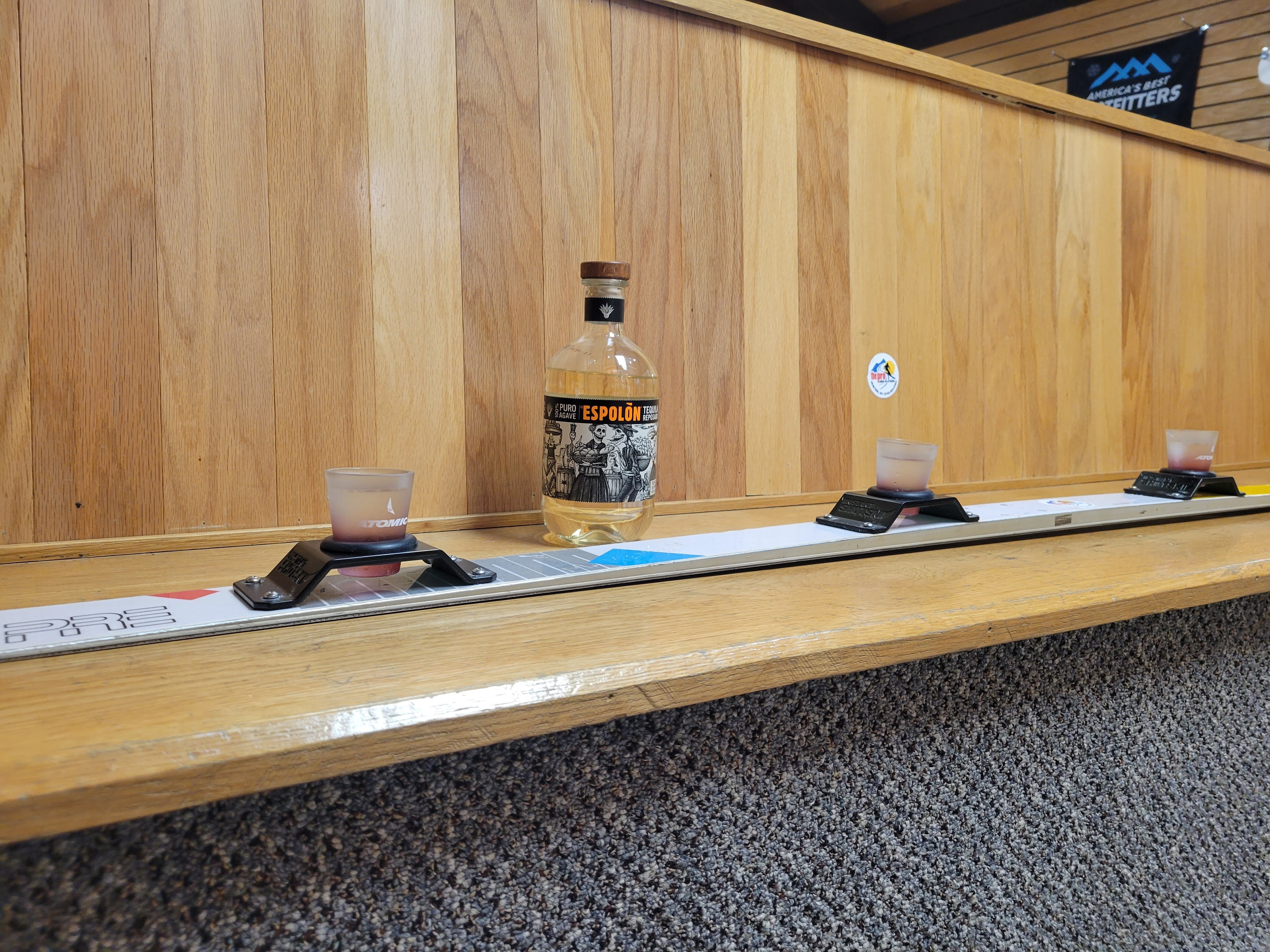 Custom vintage shot ski with mounted shot glasses on rustic wood background
