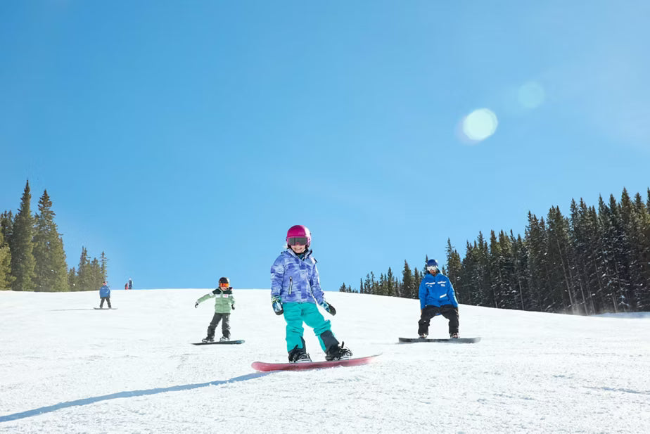 Kids Snowboarding on Sunny Day